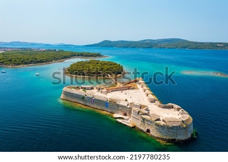 Aerial view about St. Nicholas Fortress (Croatian: Tvrđava sv. Nikole) which located at the entrance to St. Anthony Channel, near the town of Šibenik in central Dalmatia, Croatia. Royalty-Free Stock Photo #2197780235