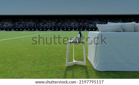 Armchair with coffee table on the background of a soccer field. Space on the left for text. Watch sports on HDTV. 