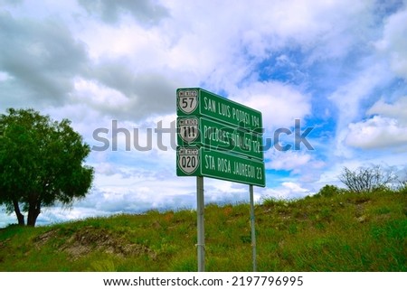 Signpath in road in green color with white letters. Signpost in the middle of the road.