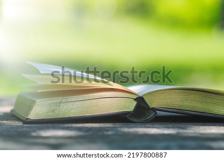 Retro thick book and green background Royalty-Free Stock Photo #2197800887