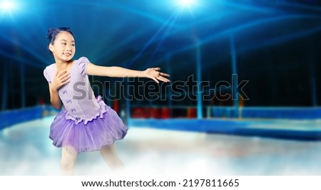 Little girl figure skating on a skating rink. Figure skating competition. Ice show. Royalty-Free Stock Photo #2197811665