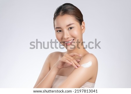 Model applying body lotion cream . Gorgeous quality cream lotion is applying by beauty model on her body showing healthy skin of the model improved by the body lotion cream . Royalty-Free Stock Photo #2197813041
