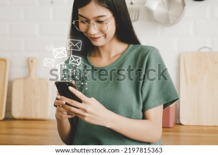 Email marketing and newsletter concept. Woman using mobile smartphone and sending online message with email icon