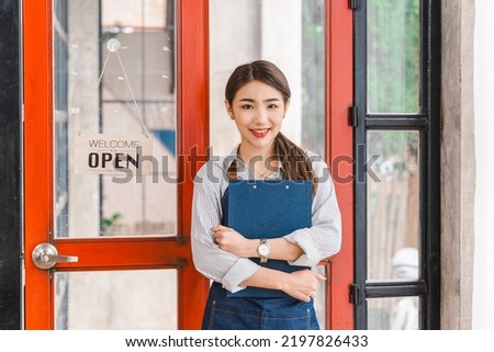 Happy Young Asian business owner freelancer woman standing with open sign.
