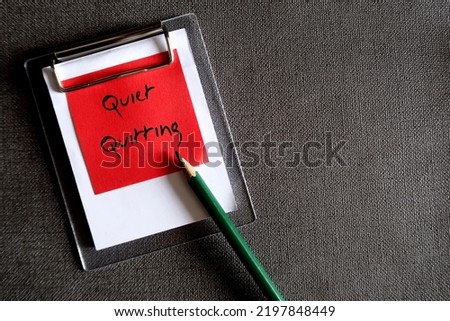Wall paper copy space background, red note with handwritten text QUIET QUITTING - concept of doing only what job demands and nothing more, not taking corporate job too seriously Royalty-Free Stock Photo #2197848449