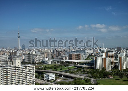 Tokyo downtown skyscrapers with the Skytree on blue sky and white clouds background
