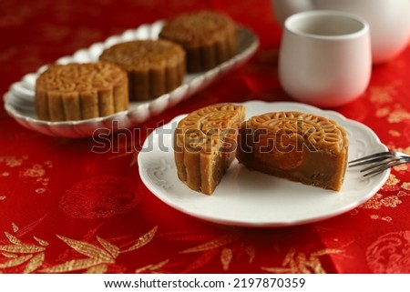 Close up moon cakes with red background. Mooncake is a traditional Chinese bakery. Often eating on Mid-Autumn Festival or lunar appreciation festival.