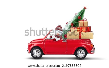 Snowman driving red car with christmas gifts and christmas tree isolated on a white background.