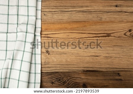 Empty wooden table with checkered tablecloth mockup. Rustical kitchen background, rustic minimal still-life with cloth napkin fabric, towel copy space