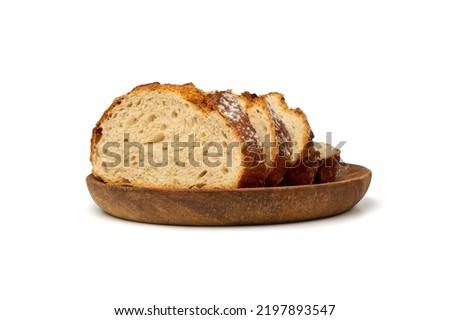 Traditional Homemade Sliced Bread on Wooden Plate Isolated. Brown Organic Cereal Bread Pieces, Round Loaf Slices on White Background Side View Royalty-Free Stock Photo #2197893547