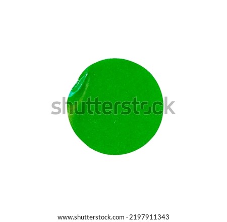 Adhesive paper sticker label green circle pattern with a folded edges isolated on white background , clipping path	