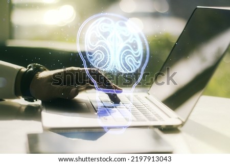 Double exposure of creative light bulb hologram with human brain and with hands typing on laptop on background, idea and brainstorming concept