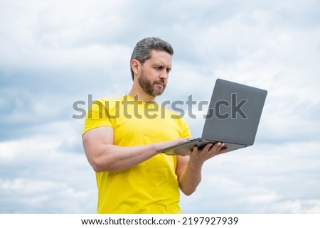 man working online on laptop on sky background. communication