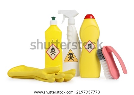 Bottles of toxic household chemicals with warning signs, gloves and brush on white background