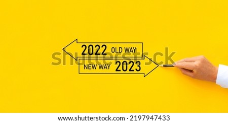 Businessman draw arrow panel with Old Way 2022 and New way of the  year 2023. Improvement and change management.  Royalty-Free Stock Photo #2197947433