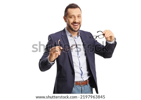 Young man holding two pairs of glasses and smiling isolated on white background Royalty-Free Stock Photo #2197963845