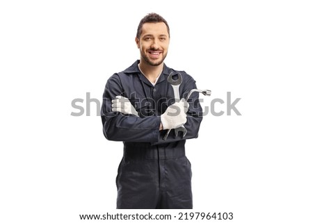 Car mechanic holding a wrench and a key tool isolated on white background