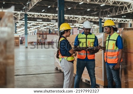 Warehouse Workers Checking Stock with digital Tablet in Logistic center. Indian Worker Team wearing hard hat and safety vests to talking about shipment in storehouse, Working in Distribution Center. Royalty-Free Stock Photo #2197992327