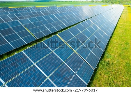 Solar panels in the green field for generation of green energy safety for environmental  Royalty-Free Stock Photo #2197996017