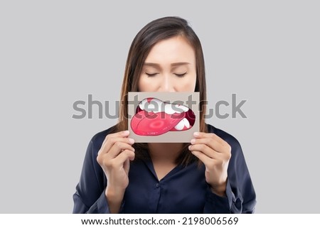 Aphthous Ulcers, The woman show the picture of tongue problems Royalty-Free Stock Photo #2198006569