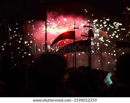 silhouette of a scythe and fireworks in the background. selective focus out-of-focus background