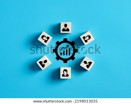 Performance improvement, brainstorm, joint efforts to solve problems, teamwork or working on a common project. Ascending graph icon surrounded by wooden cubes with employee symbols.