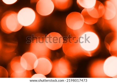 Blurred lights, dark orange background. Abstract bokeh with soft light
