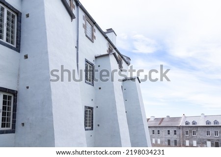 Detail of the 18th Century Dauphine Redoubt east facade and old soldier houses seen during a cloudy afternoon, Quebec City, Quebec, Canada Royalty-Free Stock Photo #2198034231