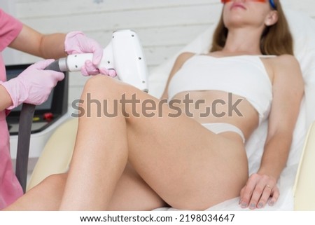 laser hair removal legs. Laser epilation and cosmetology. Hair removal cosmetology procedure. Laser epilation and cosmetology. Cosmetology and SPA concept Royalty-Free Stock Photo #2198034647