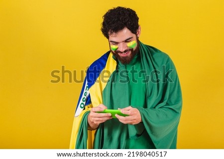 caucasian man with beard, brazilian, soccer fan from brazil, playing mobile game, mobile game.