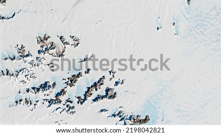 Meteorite in Antarctica, top view of snow rock peaks background texture. Elements of this image furnished by NASA.