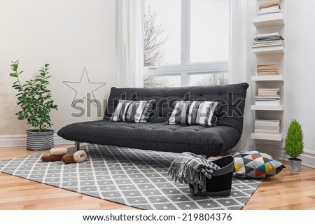 Spacious living room with gray sofa and modern decor. Royalty-Free Stock Photo #219804376