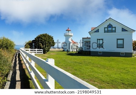 Mukilteo Lighthouse on a sunny day. The lighthouse is an operational navigation aid located on the east side of Possession Sound at Mukilteo, Snohomish County, Washington. Royalty-Free Stock Photo #2198049531