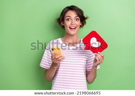 Photo of impressed lady arm hold telephone red paper approval symbol sign use modern device gadget isolated on green color background