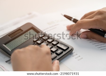 Woman working on financial bill paper document do home accounting to plan monthly expense. Businesswoman calculating debt from bill receipt during inflation crisis.