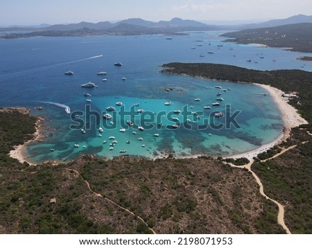 Aerial view of Spiaggia dei Ricci, near White Beach and Cala Petra Ruja in Sardegna. Drone view of turquoise and idyllic water with yacht between Porto Rotondo and Porto Cervo, north Sardinia, Italy. Royalty-Free Stock Photo #2198071953