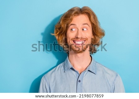 Photo of sweet cunning man wear denim shirt looking empty space smiling isolated blue color background Royalty-Free Stock Photo #2198077859