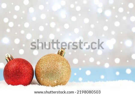 Christmas balls on the background of blurry lights of garlands. Christmas card. New Year's composition