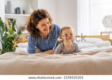 Love of mother and baby. Happy family in the bedroom at home.