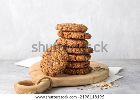 Healthy oatmeal cookies with dates, nuts and flaxseed on a wooden board on a gray textured background. Delicious homemade vegan food Royalty-Free Stock Photo #2198118195