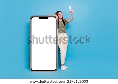 Full body photo of funny young lady do selfie near promo wear casual cloth isolated on blue background