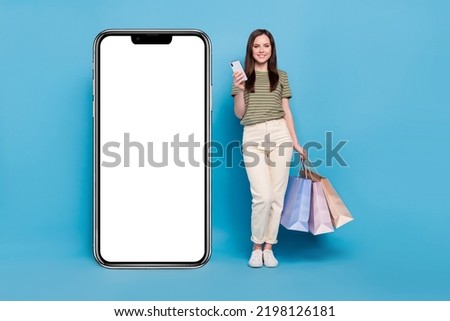 Full body photo of lady hold bags telephone wear casual cloth isolated on blue background