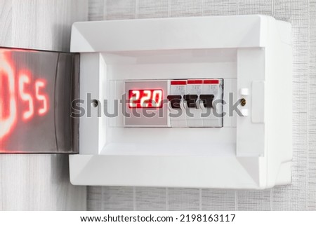 Voltage relay with indication of incoming voltage and residual current device in the switchboard on the wall of the apartment Royalty-Free Stock Photo #2198163117