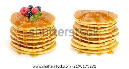 Pancakes stack with different berries and honey isolated on white background Royalty-Free Stock Photo #2198173291