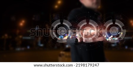 Businessman clicks on a smiley with a smile on a blurred background.