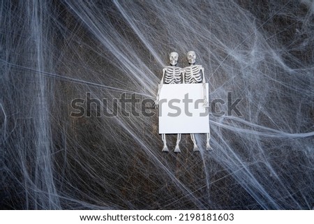 Halloween concept ,web with skeletons on a black background with a place for text ,mockup