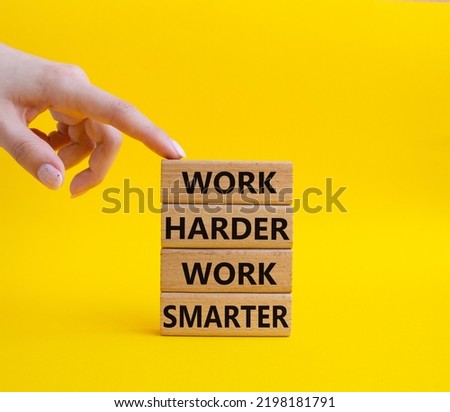 Work harder Work smarter symbol. Wooden blocks with words Work harder Work smarter. Beautiful yellow background. Businessman hand. Business concept. Copy space.