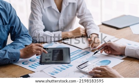 Close-up of hands of a group of business people working together in the office meeting and planning new marketing idea, presenting new business project and analyzing quarterly earning.
