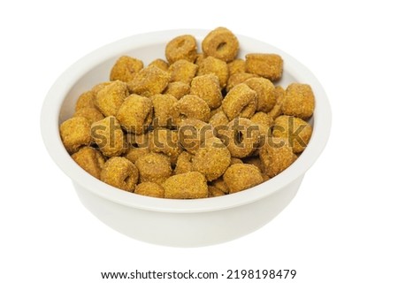 Food is good for animals. Dry food for dogs or cats in a white bowl isolated on a white background.