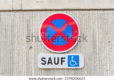 No parking sign, with the word in French except disabled.